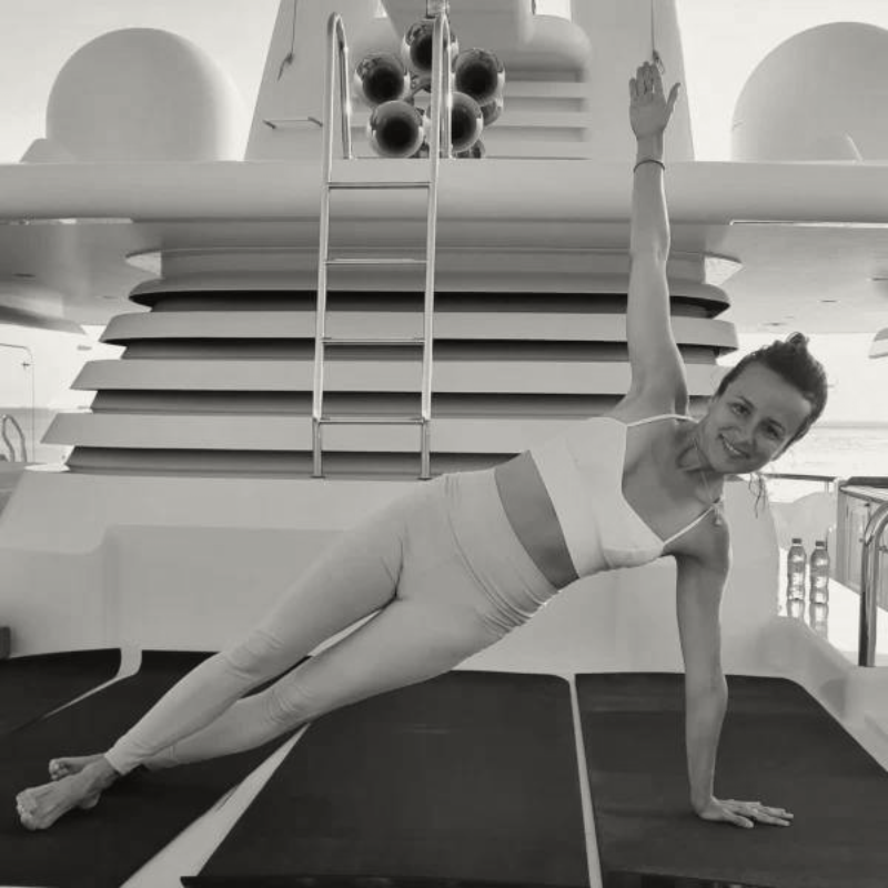 A personal trainer leading a customized fitness workout on a superyacht deck